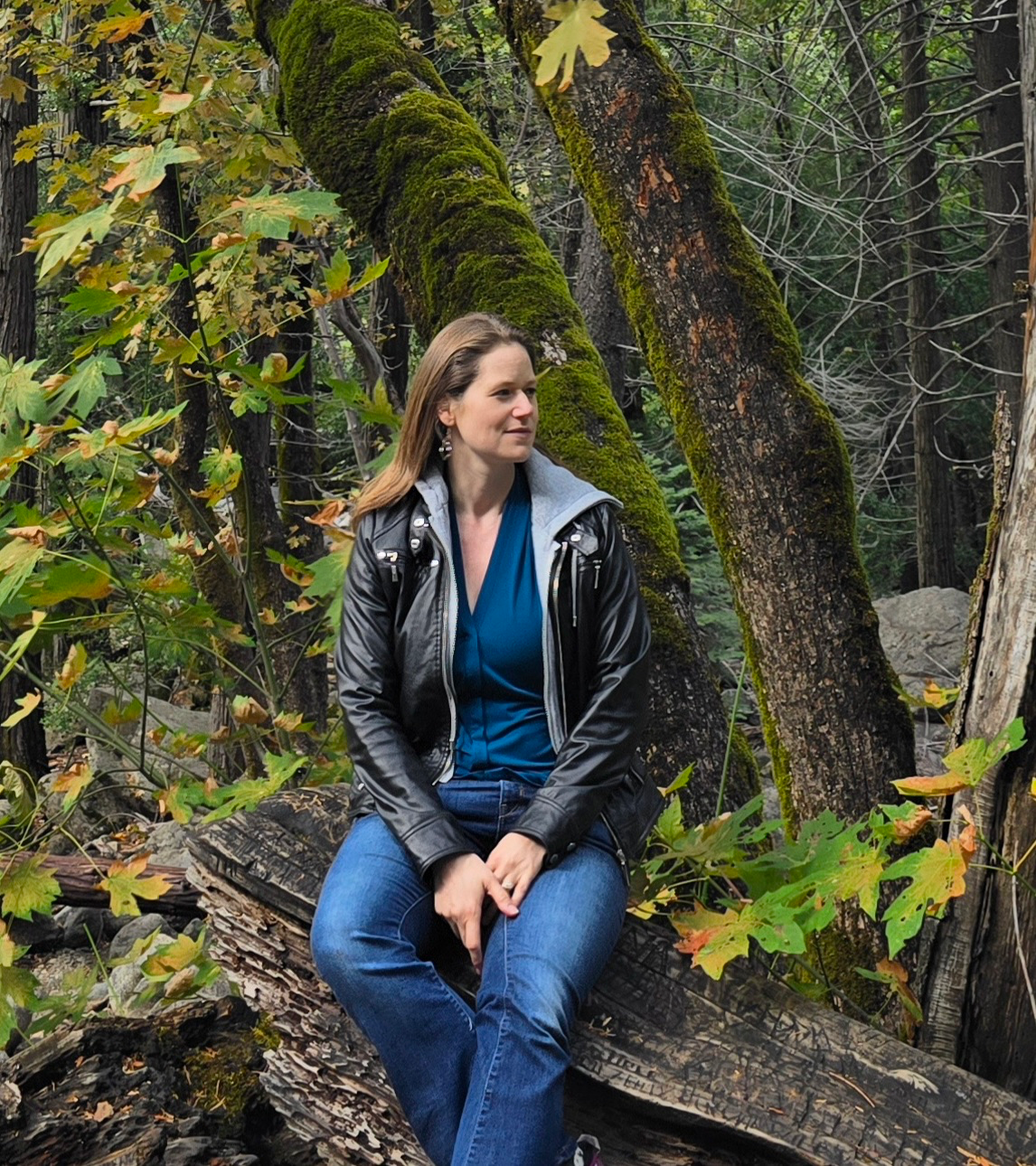 Author Valerie Sirenko looking off into a forest